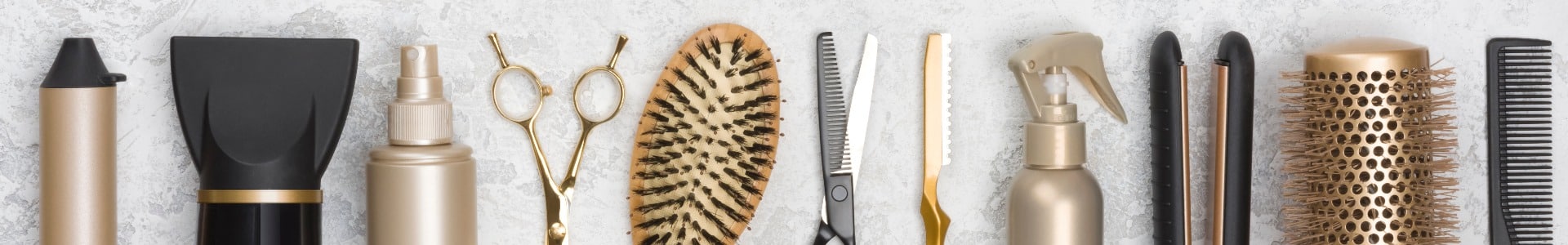 Collection of hairdresser tools on marble background with copy space